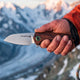 Mountaineer knife in hand on the ridge