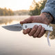 Peace knife in the hand of a veteran at home