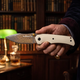 Monarch Damascus folding knife in hand