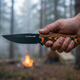 Sabertooth fixed blade knife in hand